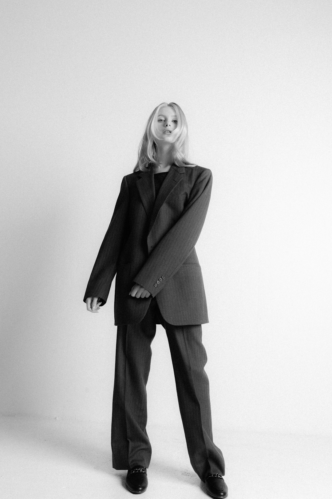 Studio portrait of a smiling woman with short blonde hair in business attire