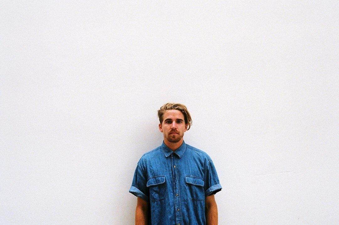 Studio portrait of a bearded man in a blue shirt